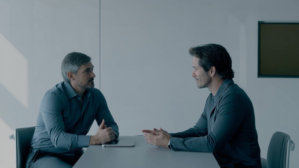 Two people calmly working through a disagreement over documents at a table