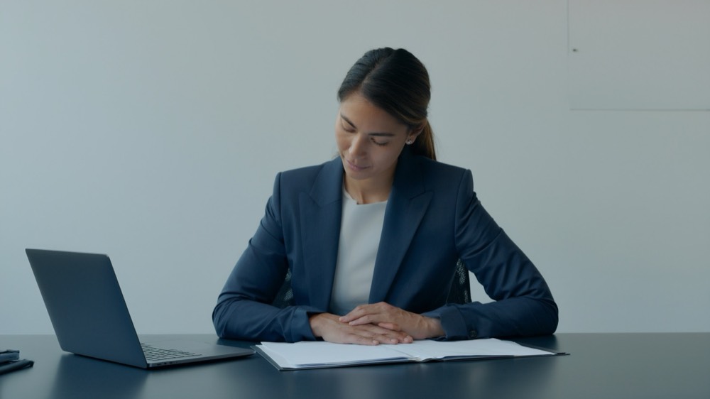 An organised folder of insurance and building documents on a desk