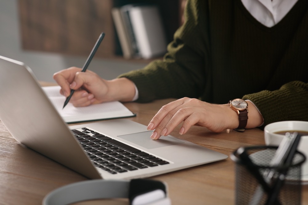 Student studying a real estate course online at a laptop at home